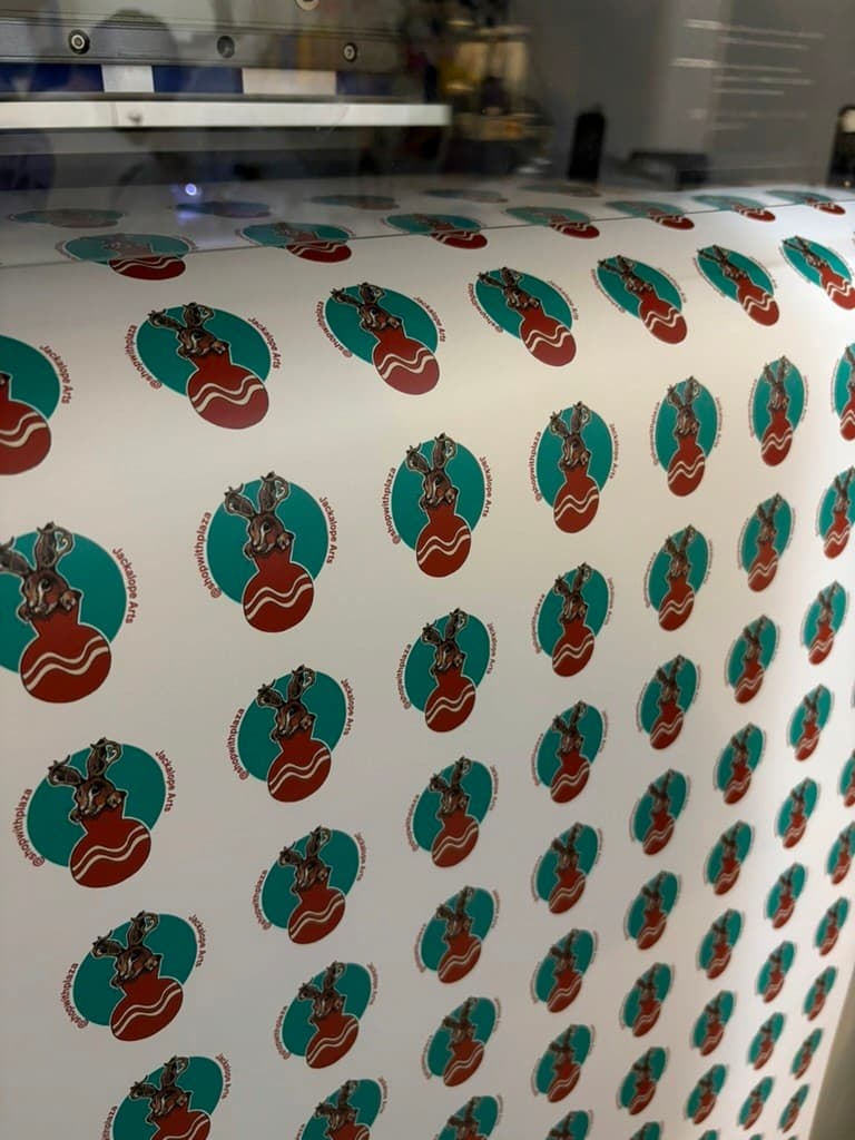 A sheet of freshly printed Plaza × Jackalope stickers