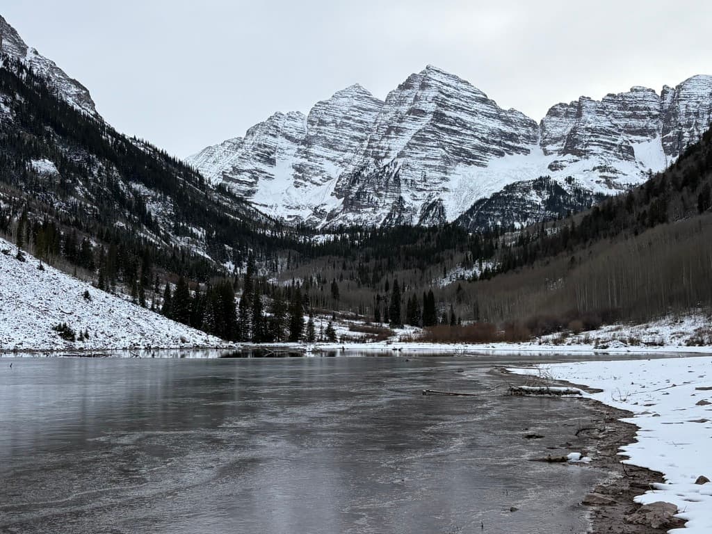 Snowy peaks above a half-frozen lake